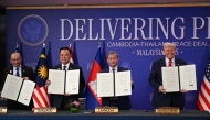 (From L to R) Malaysia's Prime Minister Anwar Ibrahim, Thailand's Prime Minister Anutin Charnvirakul, Cambodia's Prime Minister Hun Manet and US President Donald Trump take part in the ceremonial signing of a ceasefire agreement in Kuala Lumpur on October 26, 2025. (Photo by Andrew Caballero-Reynolds / AFP)
 