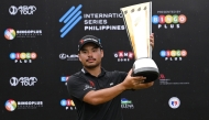 Philippines' Miguel Tabuena holds up the trophy after winning the International Series Philippines golf tournament at Sta. Elena Golf Club in Santa Rosa, Laguna province on October 26, 2025. (Photos by Ted Aljibe / AFP)