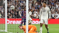 Real Madrid's English midfielder #05 Jude Bellingham scores his ream's second goal during the Spanish league football match between Real Madrid CF and FC Barcelona at Santiago Bernabeu Stadium in Madrid on October 26 , 2025. (Photo by Oscar DEL POZO / AFP)
