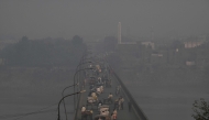 Commuters drive across a bridge amid dense smog in Lahore on October 27, 2025. (Photo by Arif ALI / AFP). Photo used for representational purposes only.