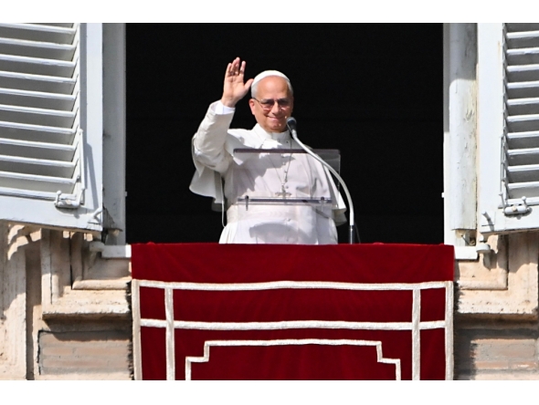 Pope Leo XIV waves to the crowd from the window of the apostolic palace overlooking St. Peter's square in The Vatican on November 2, 2025. (Photo by Andreas Solaro / AFP)

