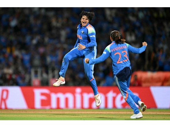 India's Shafali Verma (L) celebrates with her team captain Harmanpreet Kaur after taking the wicket of South Africa's Marizanne Kapp at the DY Patil Stadium in Navi Mumbai on November 2, 2025. (Photo by Punit Paranjpe / AFP)