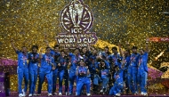 India's players celebrate with the trophy after winning the ICC Women's Cricket World Cup 2025 one-day international (ODI) final match between India and South Africa at the DY Patil Stadium in Navi Mumbai on November 3, 2025. (Photo by Punit PARANJPE / AFP)