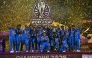 India's players celebrate with the trophy after winning the ICC Women's Cricket World Cup 2025 one-day international (ODI) final match between India and South Africa at the DY Patil Stadium in Navi Mumbai on November 3, 2025. (Photo by Punit PARANJPE / AFP)