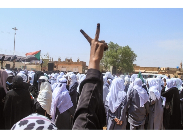 A Sudanese Student flashes the V-sign for victory as schools in the East Nile region of the capital gather during a protest against violations committed by the Rapid Support Forces (RSF) against the people of El- Fasher, in Khartoum on November 3, 2025. (Photo by Ebrahim Hamid / AFP)
