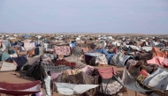 Makeshift shelters erected by displaced Sudanese who fled El-Fasher after the city fell to the Rapid Support Forces (RSF), make up the Um Yanqur camp, located on the southwestern edge of Tawila, in war-torn Sudan's western Darfur region on November 3, 2025. (Photo by AFP)