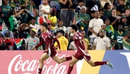 Qatar's Yazan Mohamed (left) celebrates with teammate Adam Friakh after scoring a goal against South Africa. 