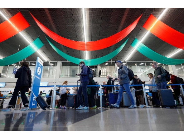 Travelers wait in line at a security checkpoint at O'Hare International Airport in Chicago, Illinois on November 7 2025. (Photo by Kamil Krzaczynski / AFP)