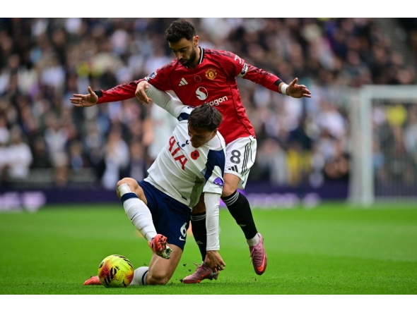 Tottenham Hotspur's Portugese midfielder #06 Joao Palhinha (L) vies with Manchester United's Portuguese midfielder #08 Bruno Fernandes (R) during the English Premier League football match between Tottenham Hotspur and Manchester United at the Tottenham Hotspur Stadium in London, on November 8, 2025. (Photo by Ben STANSALL / AFP)