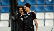 Al Sadd's Akram Afif (left) and Roberto Firmino celebrate.