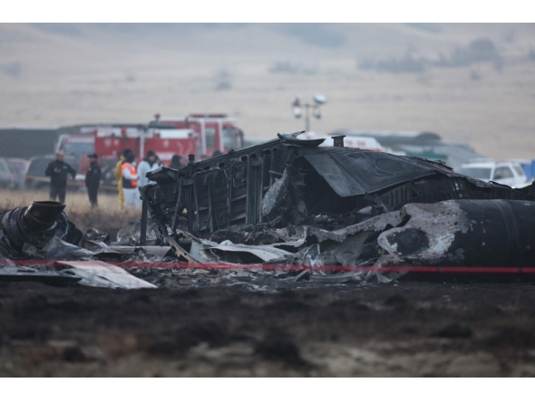 Wreckage is seen at the crash site of the Turkish C-130 military cargo plane in the Sighnaghi area at the Georgia-Azerbaijan border on November 12, 2025. (Photo by Giorgi Arjevanidze / AFP)
 