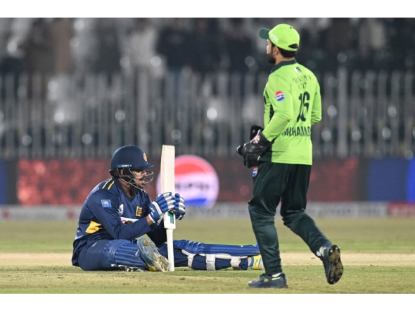 Sri Lanka's Maheesh Theekshana (L) reacts at at the end of the first one-day international (ODI) cricket match between Pakistan and Sri Lanka at the Rawalpindi Cricket Stadium in Rawalpindi on November 11, 2025. (Photo by Aamir QURESHI / AFP)