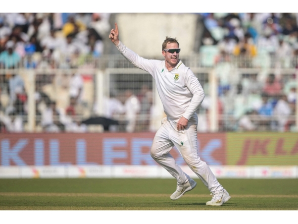 South Africa's Simon Harmer celebrates after taking the wicket of India's Kuldeep Yadav at the Eden Gardens in Kolkata on November 16, 2025. (Photo by Dibyangshu Sarkar / AFP) 