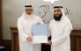 Director of the Zakat Affairs Department MalAllah Abdulrahman Al Jaber (right) honouring a company representative.