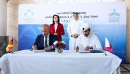 Minister of State for Foreign Trade Affairs, H E Dr. Ahmad Al Sayed and Federal Minister for Economy and Energy of Germany, H E Dr. Katherina Reiche, look on as officials sign MoU.