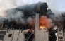 Civil defence personnel search a burning house targeted by Israeli airstrikes in Gaza City, on November 22, 2025. (Photo by Omar AL-QATTAA / AFP)
