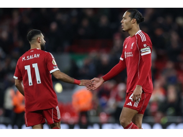 Liverpool's Dutch defender Virgil Van Dijk and Liverpool's Egyptian striker Mohamed Salah react at the end of their loss during the English Premier League football match between Liverpool and Nottingham Forest at Anfield in Liverpool, north west England on November 22, 2025. (Photo by Darren Staples / AFP)