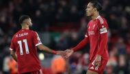 Liverpool's Dutch defender Virgil Van Dijk and Liverpool's Egyptian striker Mohamed Salah react at the end of their loss during the English Premier League football match between Liverpool and Nottingham Forest at Anfield in Liverpool, north west England on November 22, 2025. (Photo by Darren Staples / AFP)