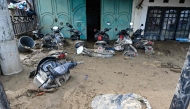 A general view shows motorcycles trapped in mud after the flash floods in Meureudu, Pidie Jaya district of Indonesia's Aceh province, on November 28, 2025. (Photo by Chaideer MAHYUDDIN / AFP)
