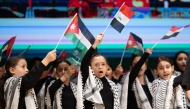 Children wave Arab flags during the event marking International Day of Solidarity with the Palestinian People.