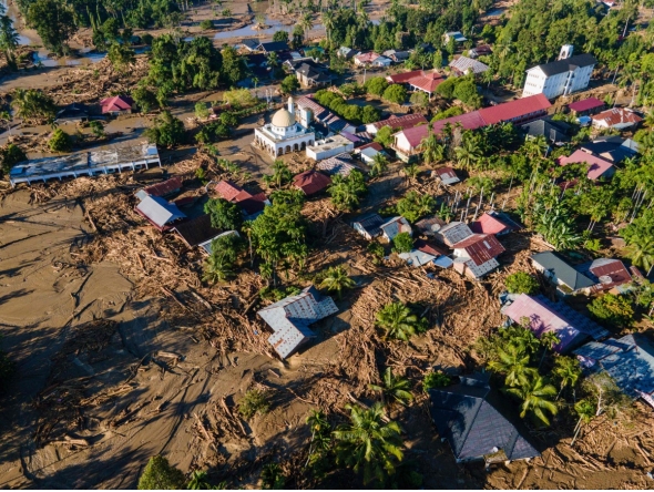 An aerial view shows flood damage in Meureudu, Pidie Jaya district in Indonesia's Aceh province on November 30, 2025. (Photo by CHAIDEER MAHYUDDIN / AFP)
