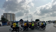Motorbike taxis carrying passengers stops at a crossroad in Cotonou following rumors of a possible coup in the country on December 7, 2025. (Photo by AFP)
 