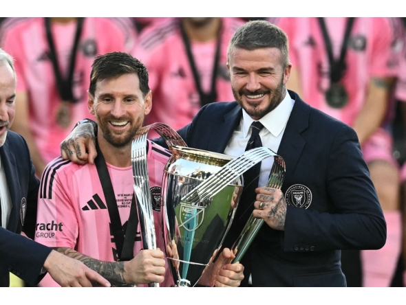 File photo of Inter Miami's Argentine forward #10 Lionel Messi (L) poses with the trophy next to the team's owner David Beckham (R) after winning the Major League Soccer (MLS) Cup final between Inter Miami and the Vancouver Whitecaps at Chase Stadium in Fort Lauderdale, Florida, on December 6, 2025.