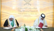 Speaker of the Shura Council H E Hassan bin Abdullah Al Ghanim and Speaker of the Shura Council of Saudi Arabia H E Sheikh Dr. Abdullah bin Mohammed bin Ibrahim Al Sheikh signing an agreement to enhance cooperation between the two councils.