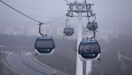 This photograph shows the first urban cable car in Ile-de-France region on the day of its official launch, in between Créteil Pointe du Lac et Limeil-Brévannes, on the outskirst of Paris, on December 13, 2025. (Photo by Thomas Samson / AFP)