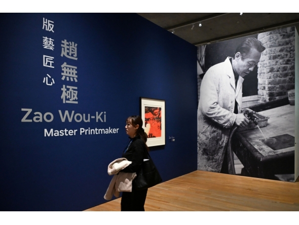 A woman attends a media preview of M+ art museums special exhibition titled 