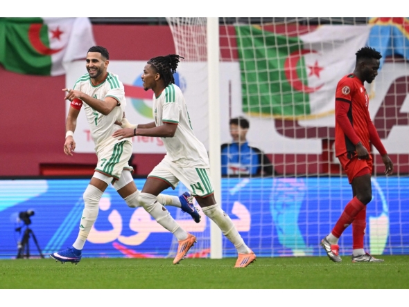 Algeria's forward #7 Riyad Mahrez (L) celebrates scoring the team's second goal with Algeria's midfielder #14 Hicham Boudaoui during the Africa Cup of Nations (CAN) Group E football match between Algeria and Sudan at Moulay Hassan Stadium in Rabat on December 24, 2025. (Photo by SEBASTIEN BOZON / AFP)
