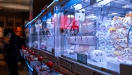 In this picture taken on November 22, 2025, stuffed toys are seen inside claw crane game machines inside a shop at Tokyo's Shinjuku district. (Photo by Philip Fong / AFP) 