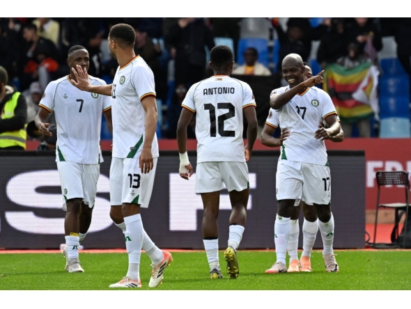 Zimbabwe's forward #17 Knowledge Musona (R) celebrates scoring the team's first goal during the Africa Cup of Nations (AFCON) Group B football match between Angola and Zimbabwe at Marrakesh Stadium in Marrakesh on December 26, 2025. (Photo by Khaled Desouki / AFP)