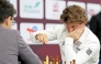 Norway's Magnus Carlsen (right) competes against Yagiz Kaan Erdogmus of Turkiye.