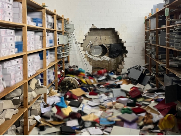 This handout photo taken on December 29, 2025 in Gelsenkirchen, Wwestern Germany, and handed out by the Police Gelsenkirchen shows a giant hole in a wall of the bank vault of a Sparkasse bank branch after the unknown perpetrator(s) broke in during the Christmas holidays. According to media reports from December 30, 2025, concerned bank customers gathered in front of the bank to find out what happened to their valuables. (Photo by Handout / Police Gelsenkirchen / AFP)