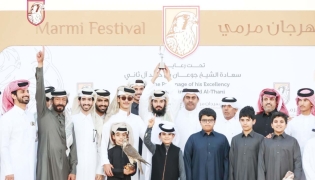 Falconers and participants after winning a competition on the first day of the festival.   