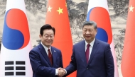South Korea's President Lee Jae Myung (L) shakes hands with China's President Xi Jinping (R) during a Memorandum of Understanding (MOU) signing ceremony at the Great Hall of the People in Beijing on January 5, 2026. Photo by YONHAP / AFP