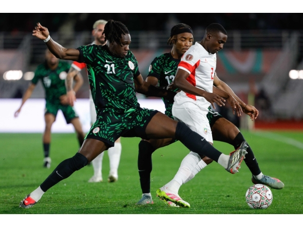 Nigeria's defender #21 Calvin Bassey (L) and Nigeria's forward #12 Cyriel Dessers close in on Mozambique's defender #02 Infren Matola during the Africa Cup of Nations (CAN) round of 16 football match between Nigeria and Mozambique at the Sports Complex stadium in Fes on January 5, 2026. (Photo by Abdel Majid Bziouat / AFP)