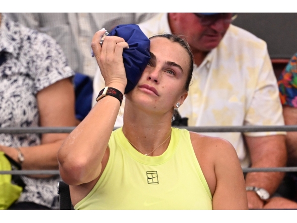 Aryna Sabalenka of Belarus places an ice pack on her head during her women's singles match against Sorana Cirstea of Romania at the Brisbane International tennis tournament in Brisbane on January 8, 2026. (Photo by William WEST / AFP)