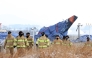 Firefighters take part in a search operation near the site where a Jeju Air Boeing 737-800 aircraft crashed and burst into flames at Muan International Airport in Muan, some 288 kilometres southwest of Seoul on January 11, 2025. Photo by YONHAP / AFP


