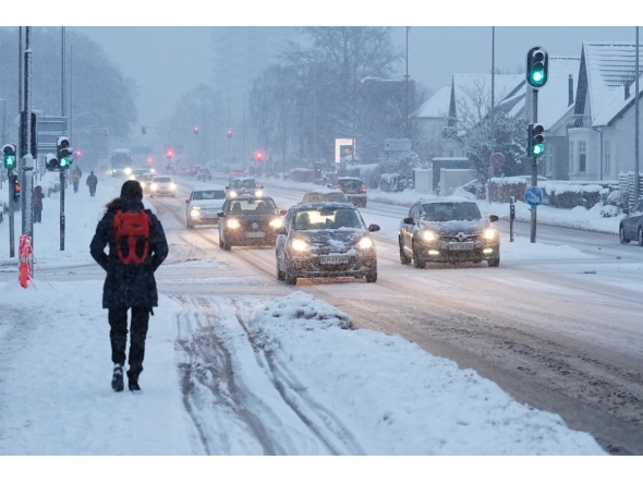 Traffic moves slowly through heavy snowfall in Aalborg, northern Denmark on January 7, 2026. (Photo by Henning Bagger / Ritzau Scanpix / AFP) / Denmark OUT
