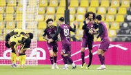 Al Sadd's Akram Afif (second right) celebrates with teammates after scoring a goal.
