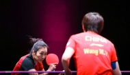 Ying Han (left) serves against Wang Manyu. 