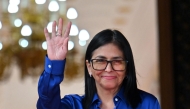 Venezuela's interim President Delcy Rodriguez waves after a press conference at the Presidential Palace in Caracas on January 14, 2026. (Photo by Juan BARRETO / AFP)

