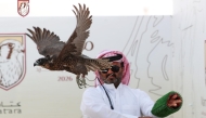 A falconer releasing his falcon during the qualification round.