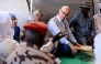 United Nations (UN) High Commissioner for Refugees, Barham Salih (2nd R), talks with a Sudanese refugee, in Farchana, Ouaddai, on January 14, 2026. (Photo by Joris Bolomey / AFP)
