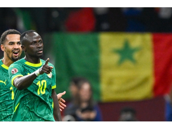 Senegal's forward #10 Sadio Mane celebrates his goal with Senegal's forward #13 Iliman Ndiaye during the Africa Cup of Nations (CAN) semi-final between Senegal and Egypt at the Grand stadium in Tangiers on January 14, 2026. (Photo by Sebastien Bozon / AFP)
