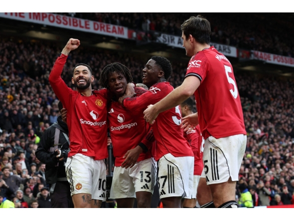 Manchester United's Danish defender #13 Patrick Dorgu (2L) celebrates with teammates after scoring their second goal during the English Premier League football match between Manchester United and Manchester City at Old Trafford in Manchester, north west England, on January 17, 2026. (Photo by Darren Staples / AFP) 