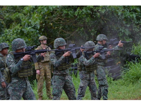 An Australian soldier (back L) supervises as Philippine Marines fire their weapons during a demonstration at Military Operation Urbanized Terrain (MOUTH) training exercises at the marine base in Ternate, Cavite province, southwest of Manila. File photo.