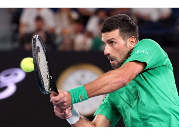 Serbia's Novak Djokovic hits a return to Spain's Pedro Martinez during their men's singles match on day two of the Australian Open tennis tournament in Melbourne on January 19, 2026. (Photo by DAVID GRAY / AFP)